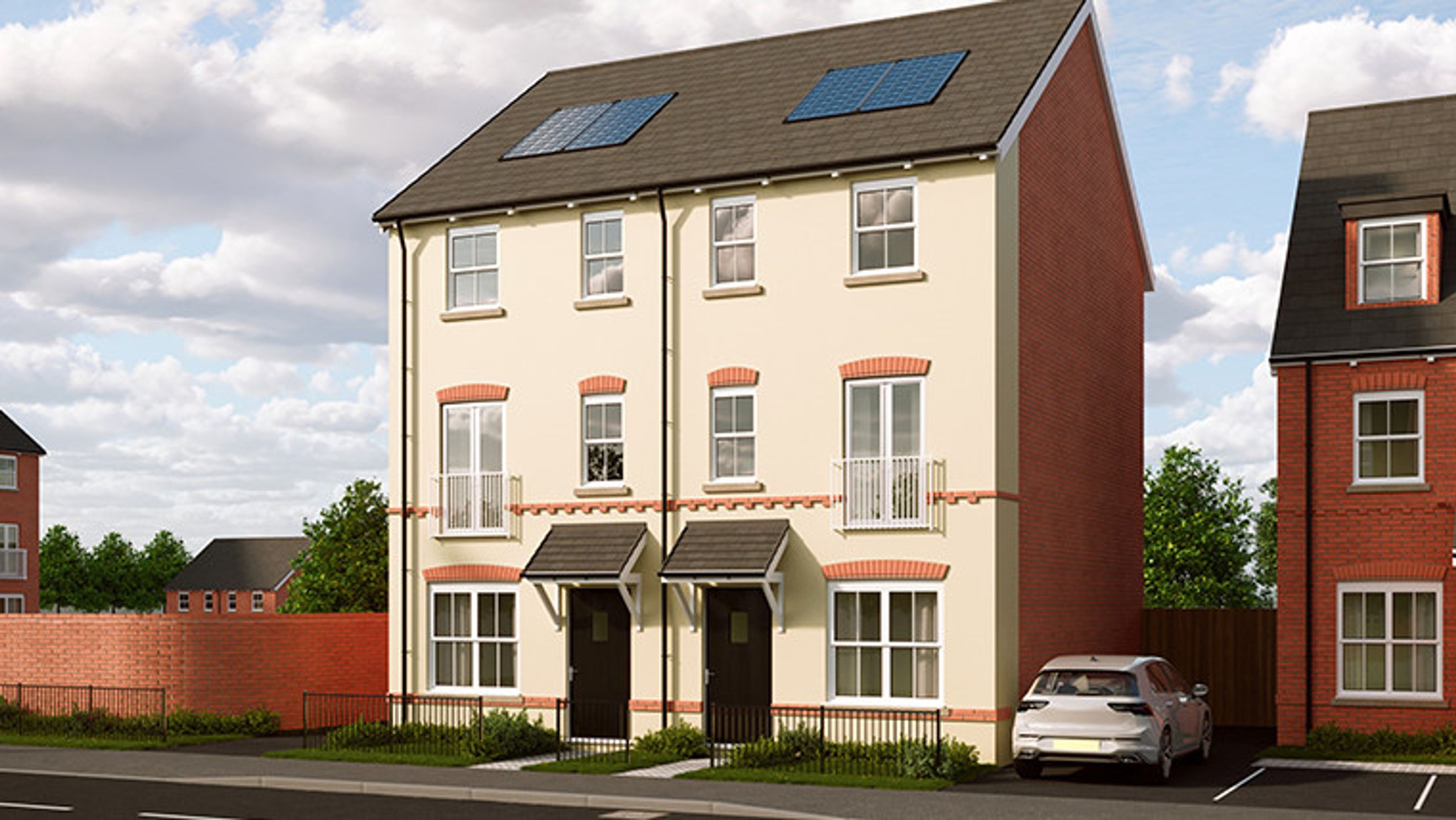 A pair of semi-detached houses with solar panels on the roof, a car parked in the driveway, and a brick wall in front.
