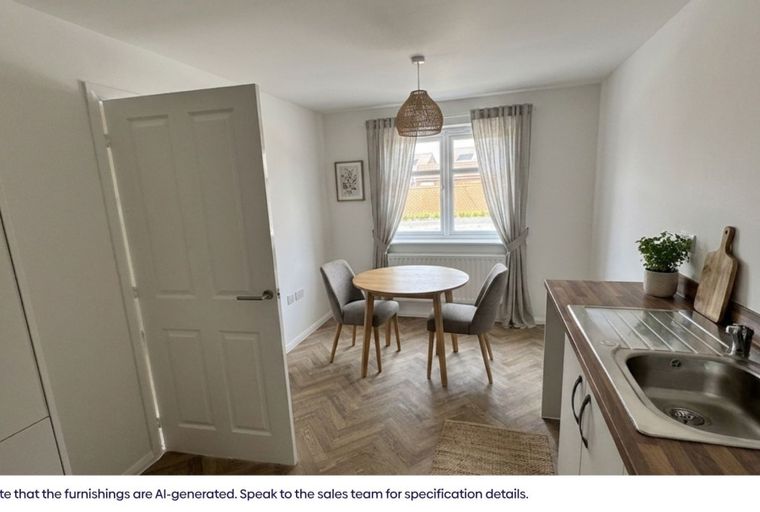 A dining area with a round table and chairs next to a kitchen counter with a sink.
