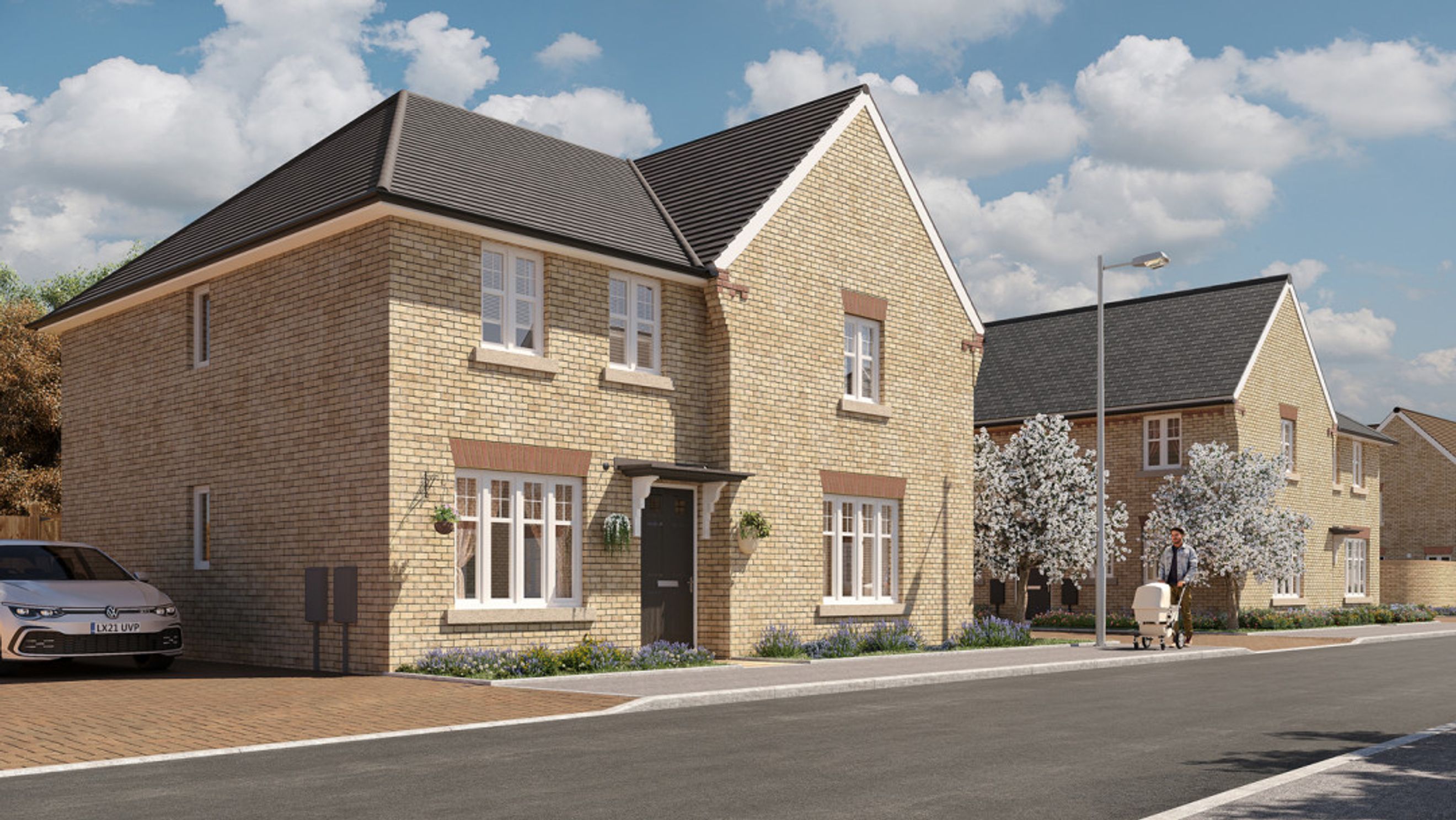 A brick-built house with a pitched roof, white-framed windows, and a driveway.