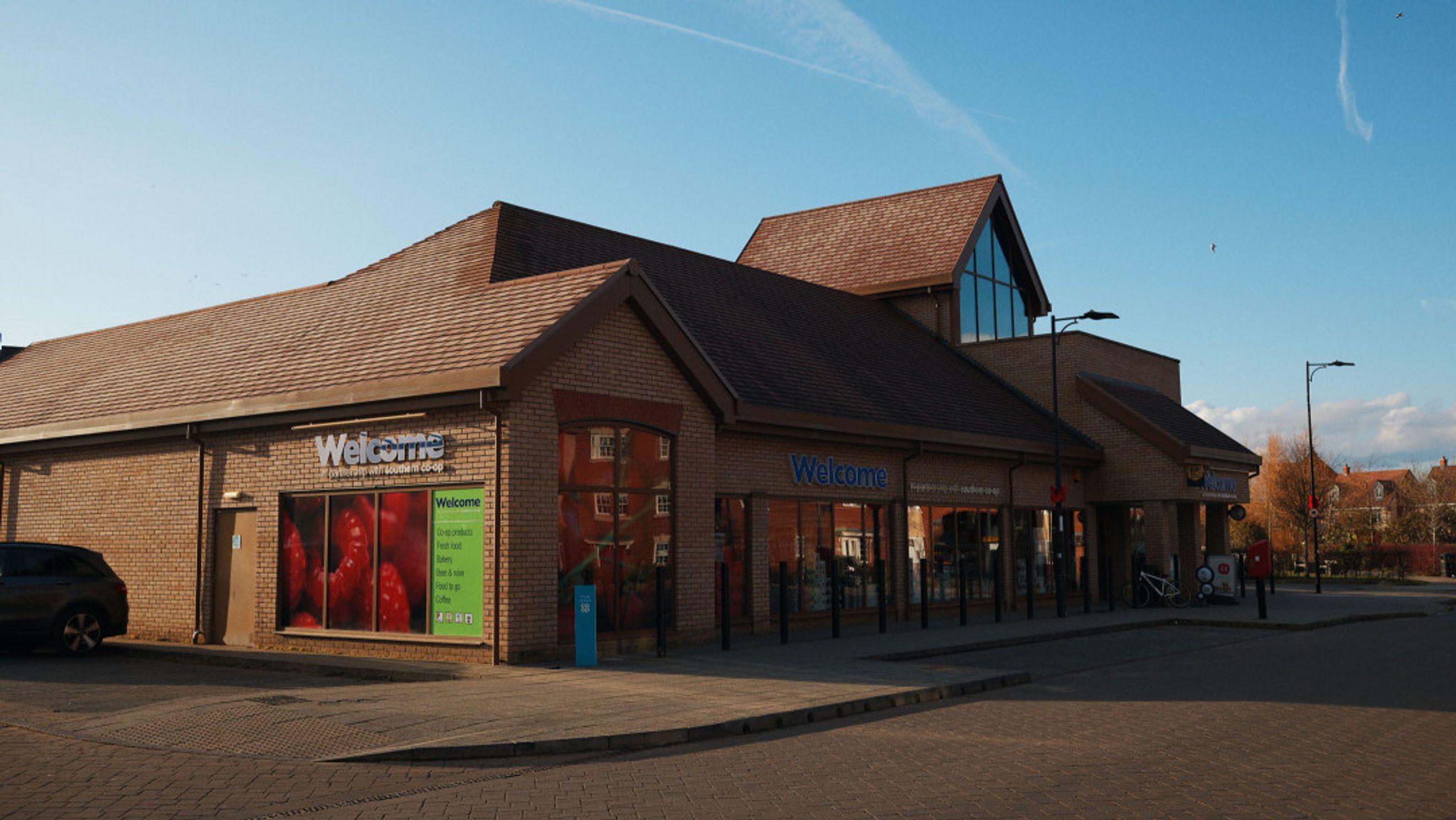 A storefront with 'Welcome' signage and large display windows.