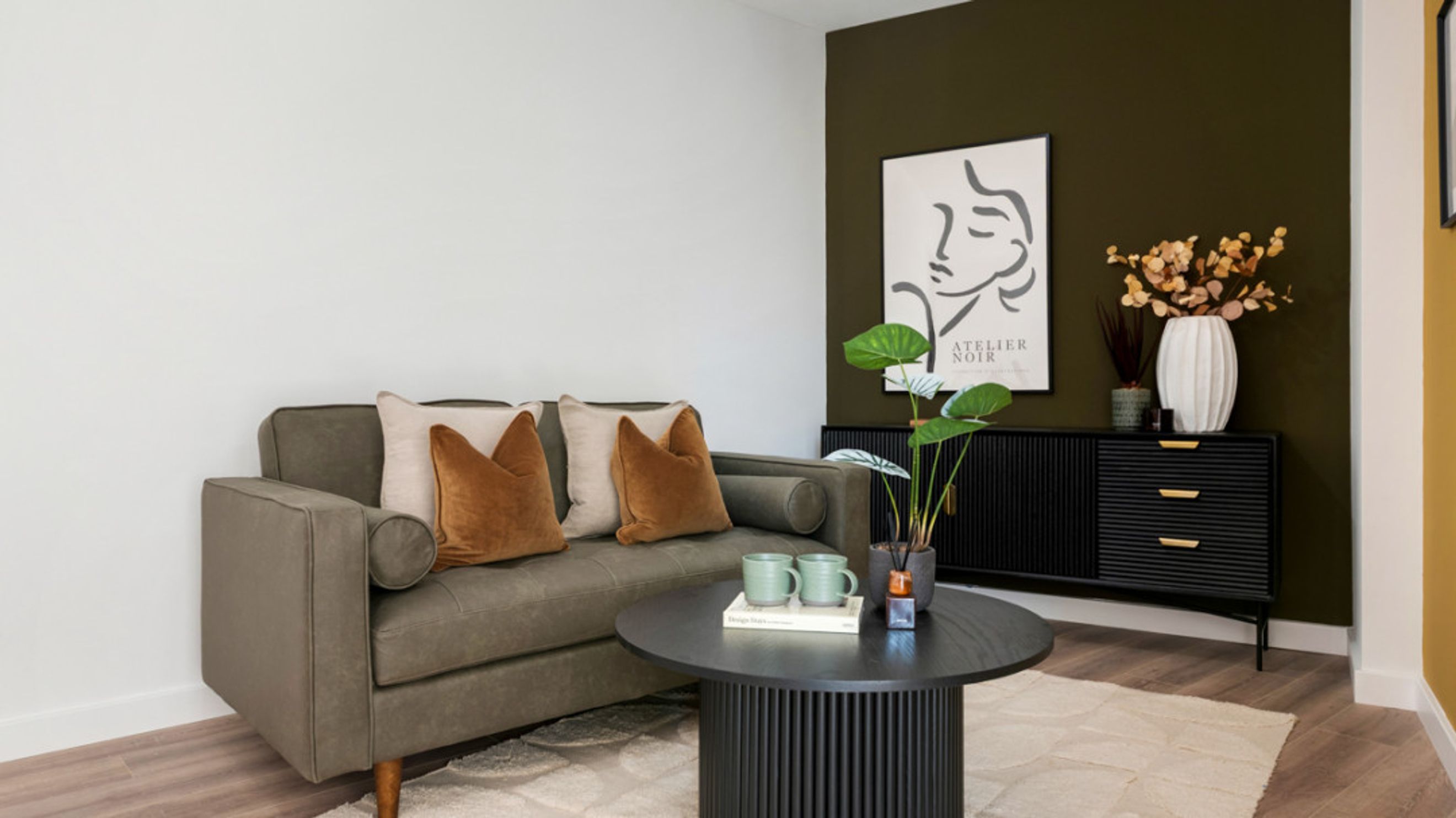 A living room with a sofa, coffee table, and a sideboard.