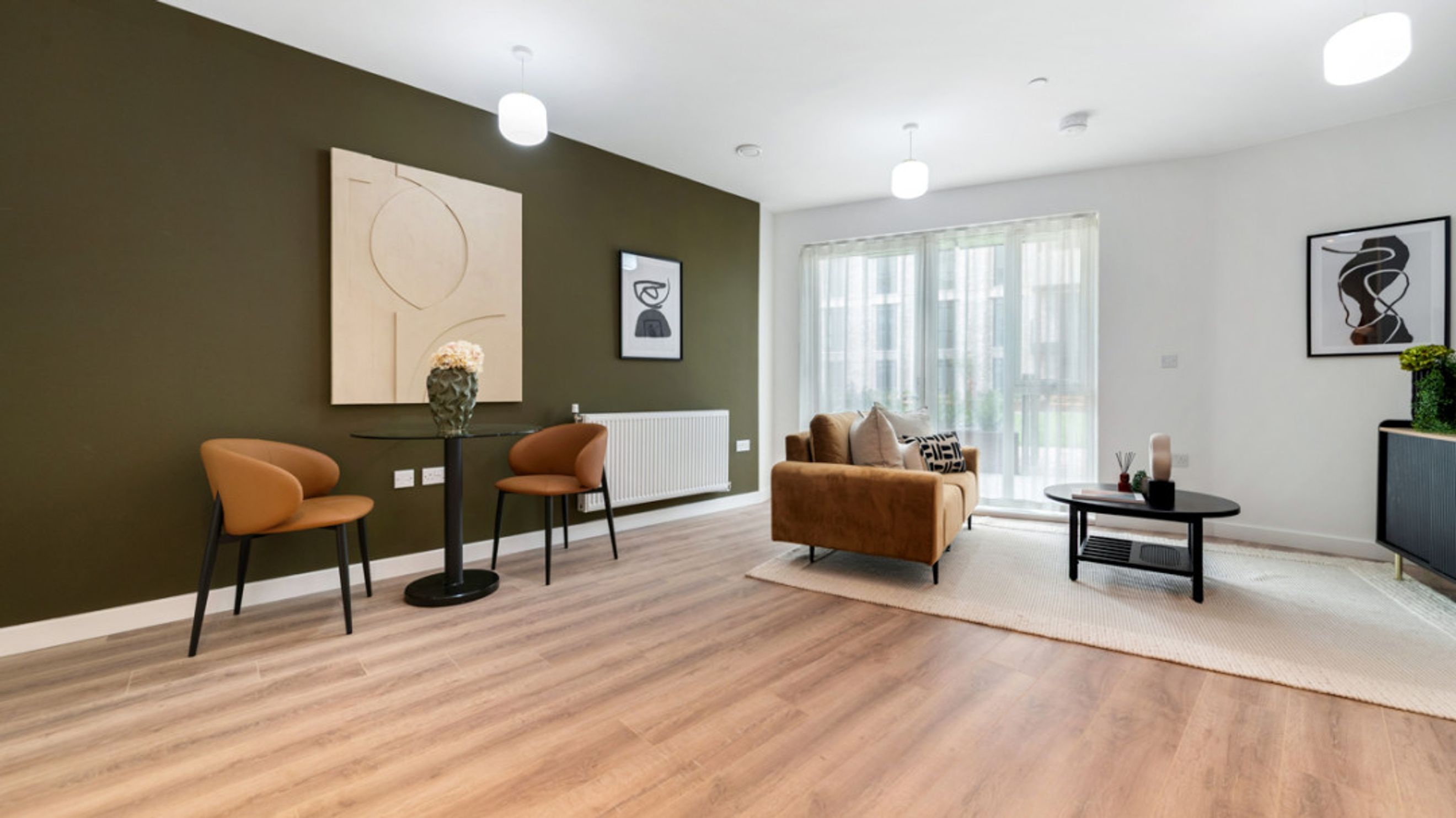 A living room with a sofa, coffee table, dining table, and chairs.