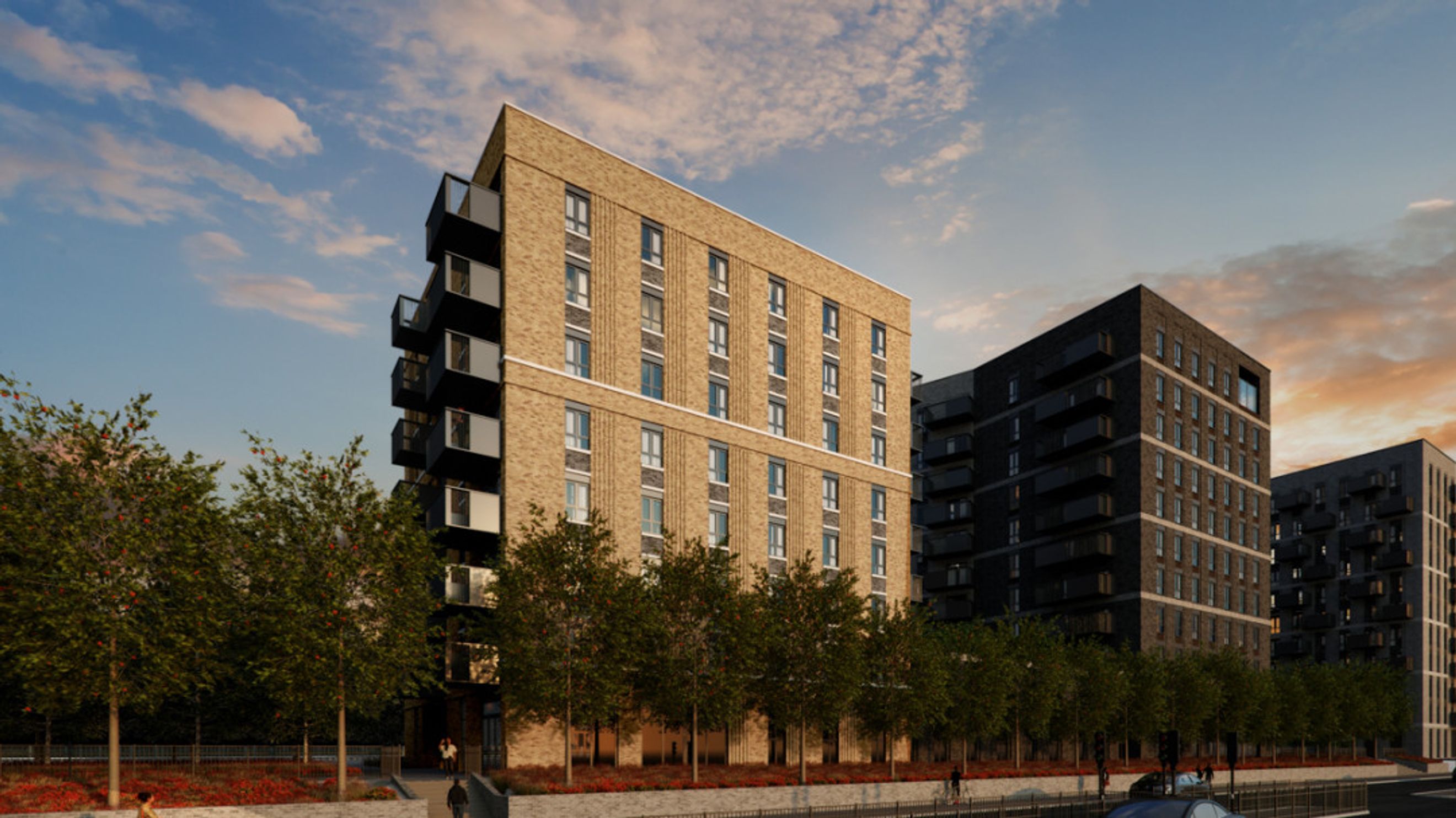A view of modern apartment buildings with balconies and trees in the foreground.