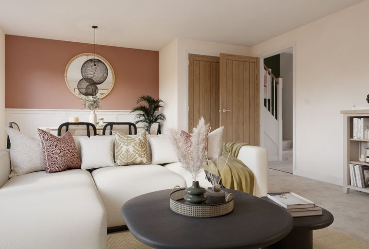 A living room with a sectional sofa, coffee table, and dining area.