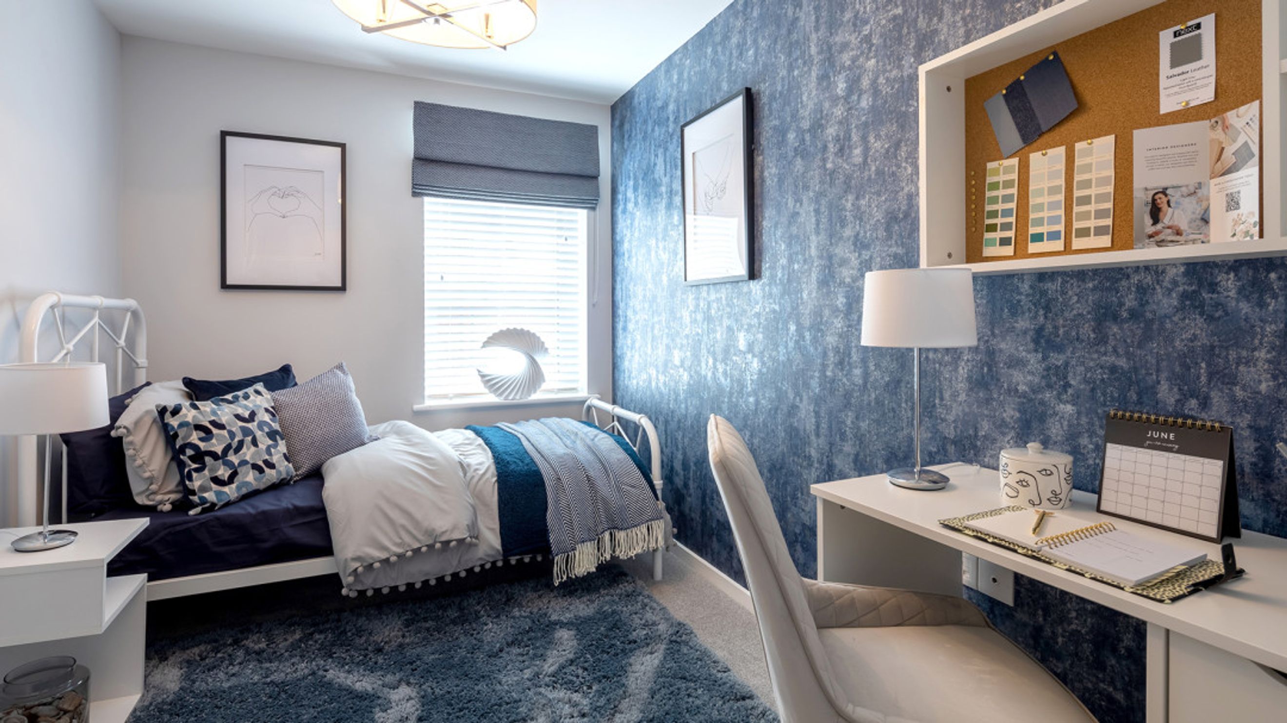 A bedroom with a bed, a desk, and a chair.