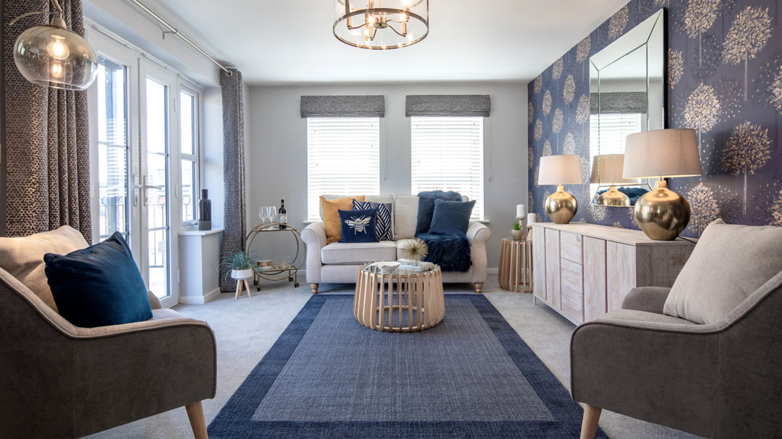 A living room with a sofa, armchairs, coffee table, and lamps.