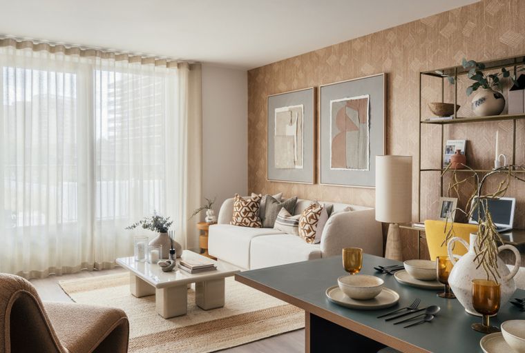 A living and dining area with a sofa, coffee table, dining table, and shelves.