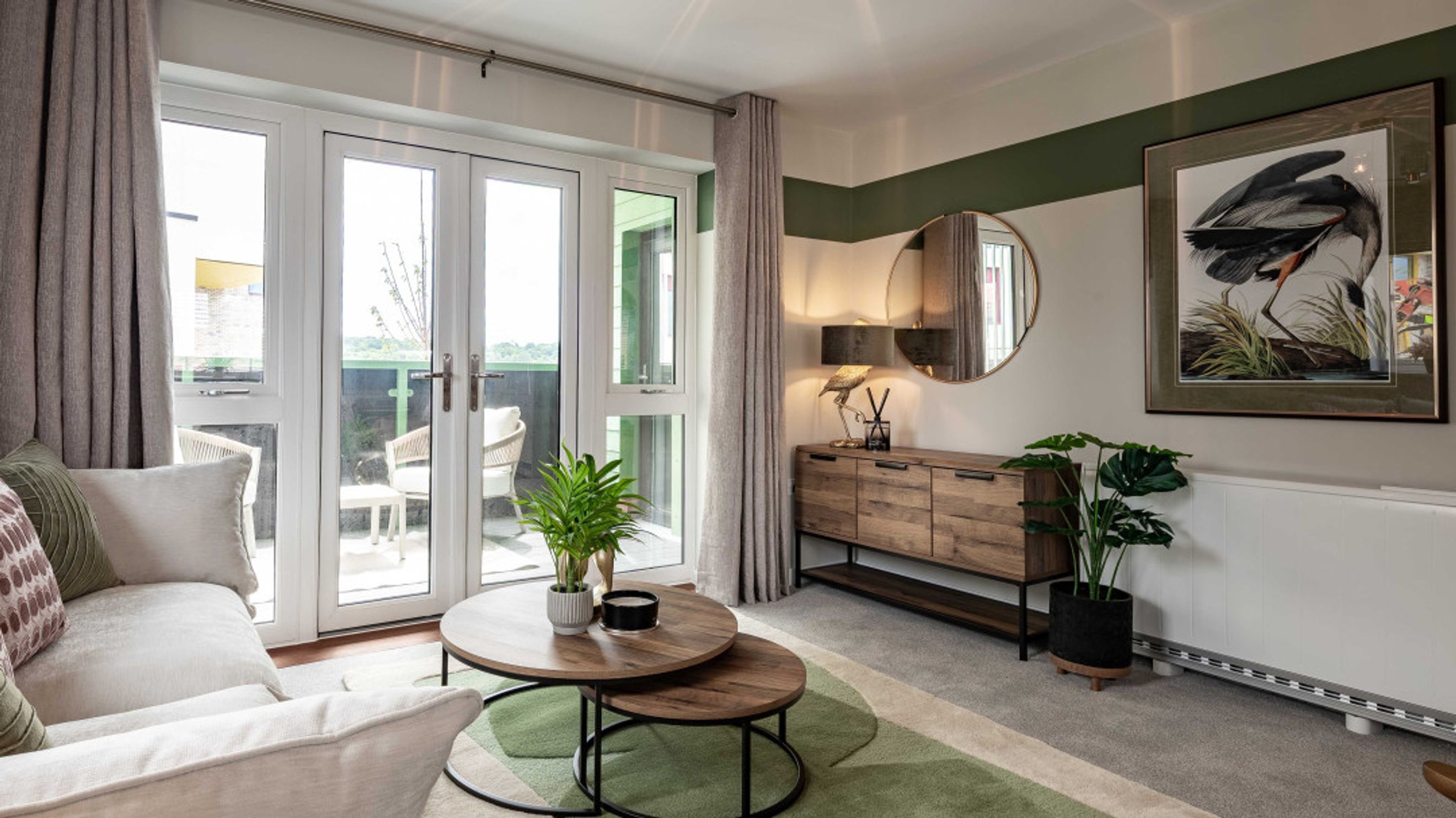 A living room with a sofa, coffee tables, a sideboard, and a balcony.