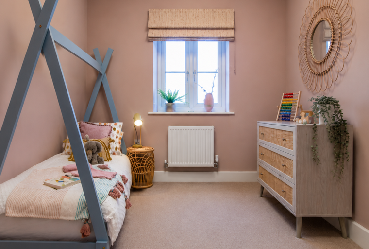 A children's bedroom with a teepee bed, a dresser, and a window.
