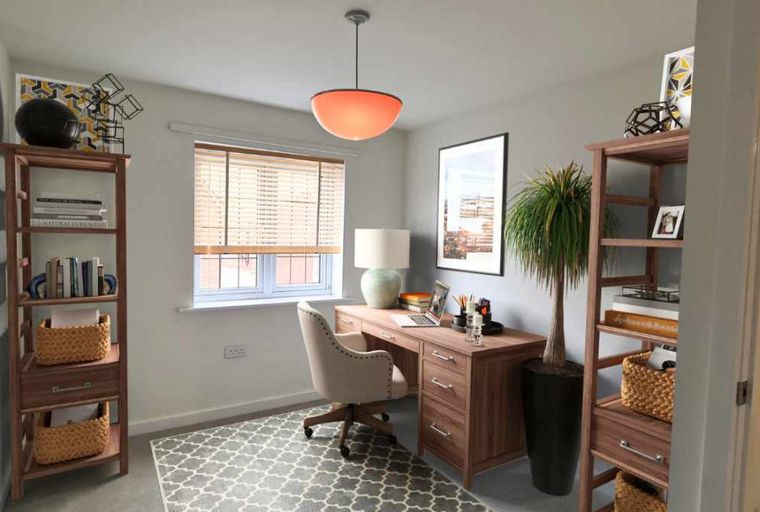 A home office with a desk, chair, and bookshelves.