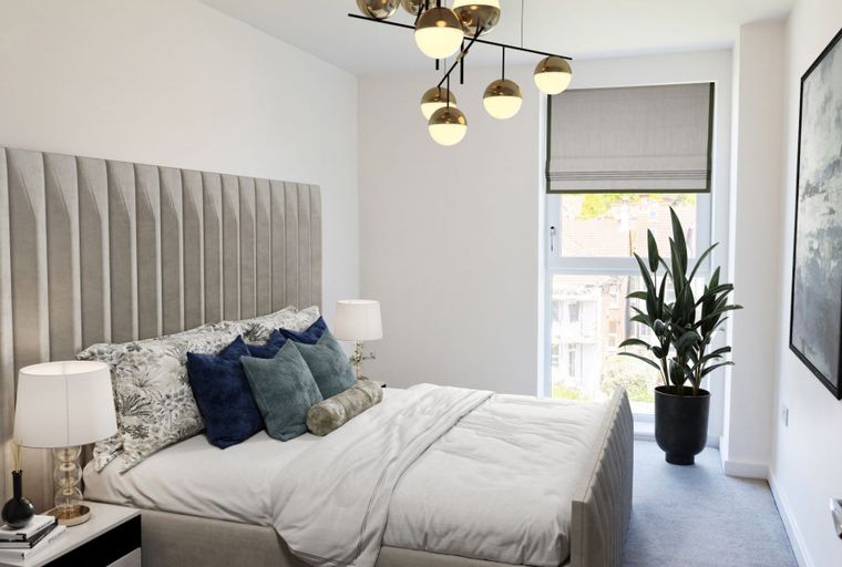 A bedroom with a bed, headboard, bedside tables, lamps, pillows, and a window.