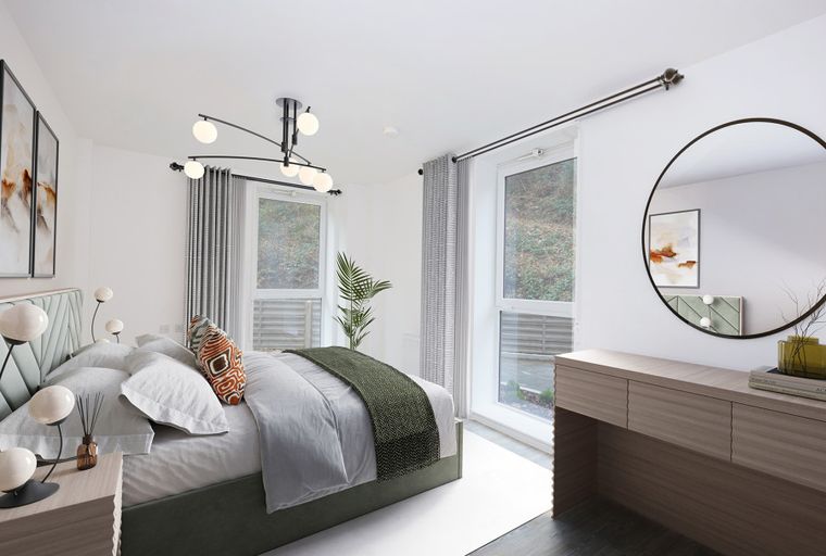A bedroom with a bed, bedside tables, artwork, and a mirror.