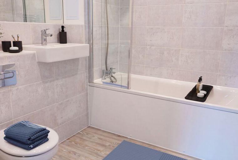 A bathroom with a bathtub, a sink, and a toilet.