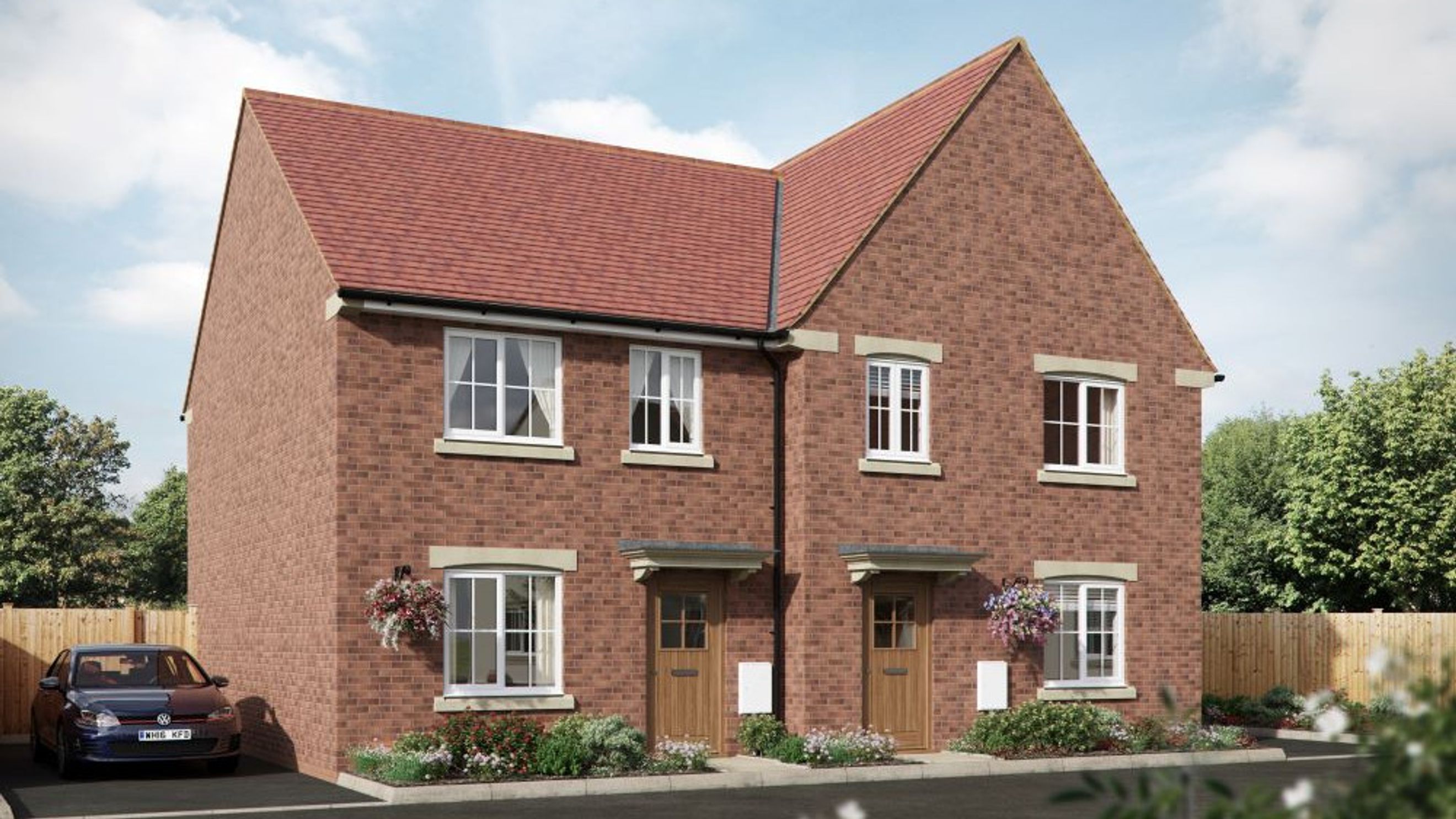 A pair of semi-detached brick houses with red tile roofs and white-framed windows.