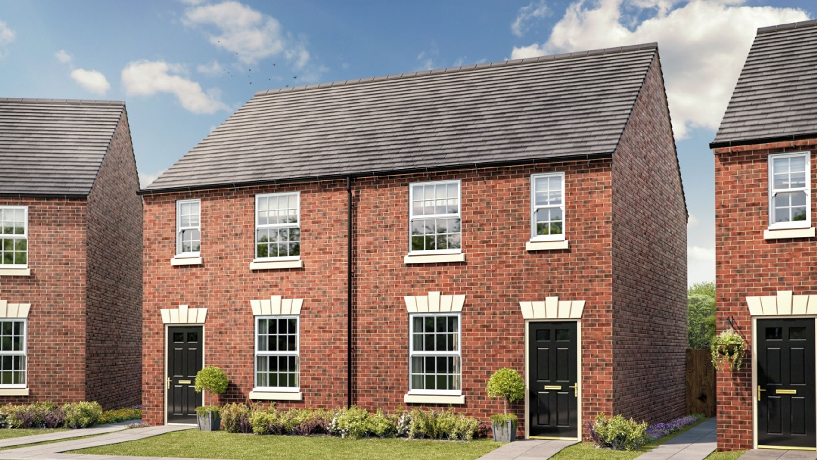 A row of red brick townhouses with black front doors and white-framed windows.