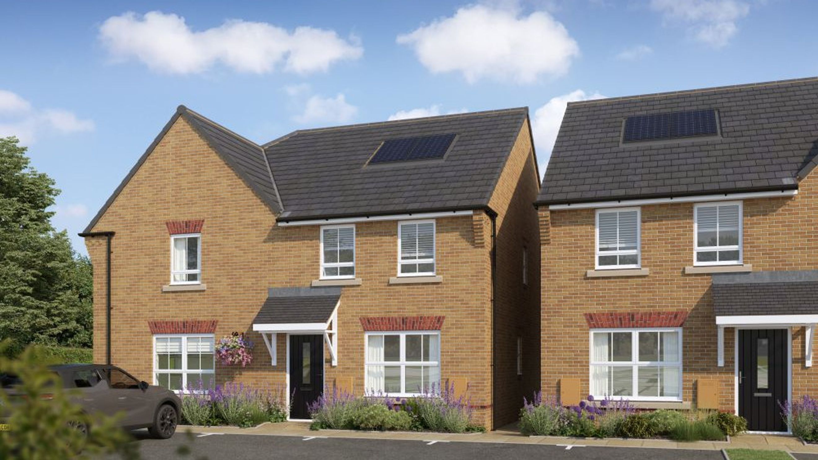 A pair of modern brick houses with solar panels on the roof, set against a blue sky with clouds.