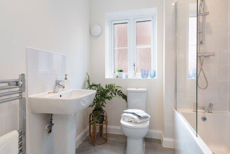 A bathroom with a sink, toilet, and bathtub.