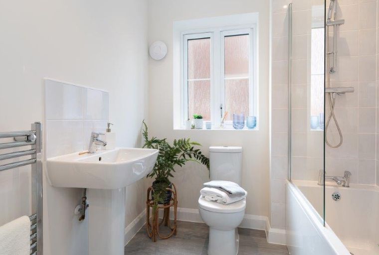 A bathroom with a sink, toilet, and bathtub.