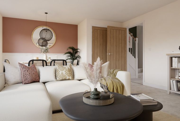 A living room with a sectional sofa, coffee table, and dining area.