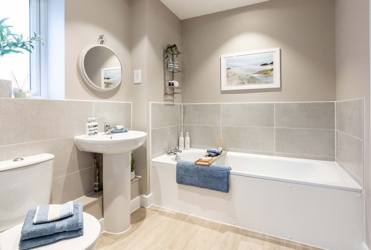 A bathroom with a bathtub, a sink, and a toilet.
