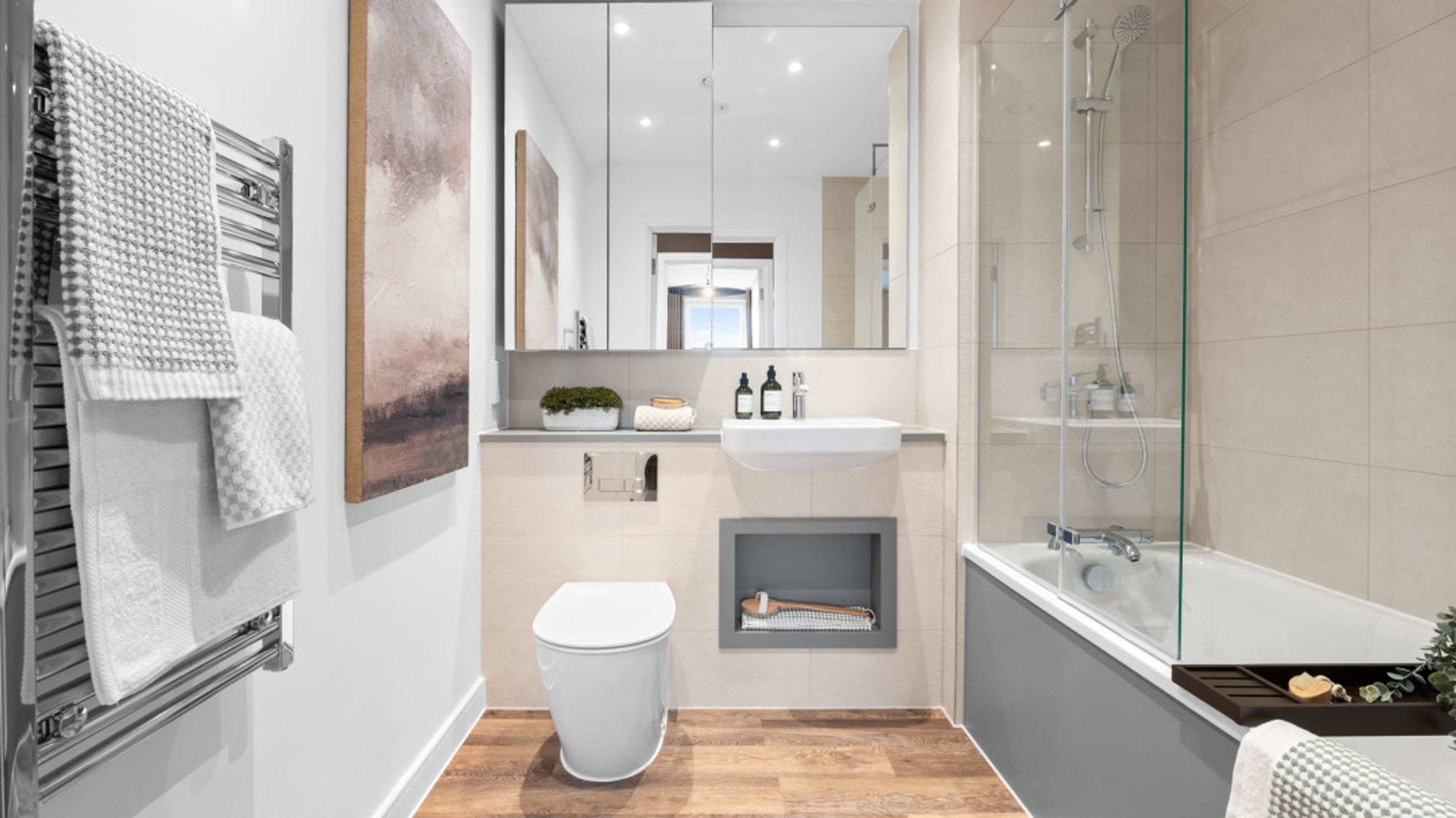 A modern bathroom with a toilet, sink, bathtub, and shower.