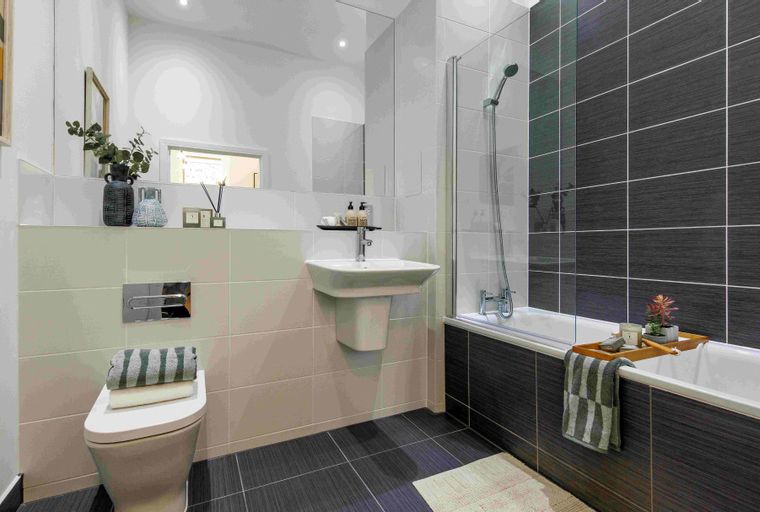 A bathroom with a toilet, sink, and bathtub.