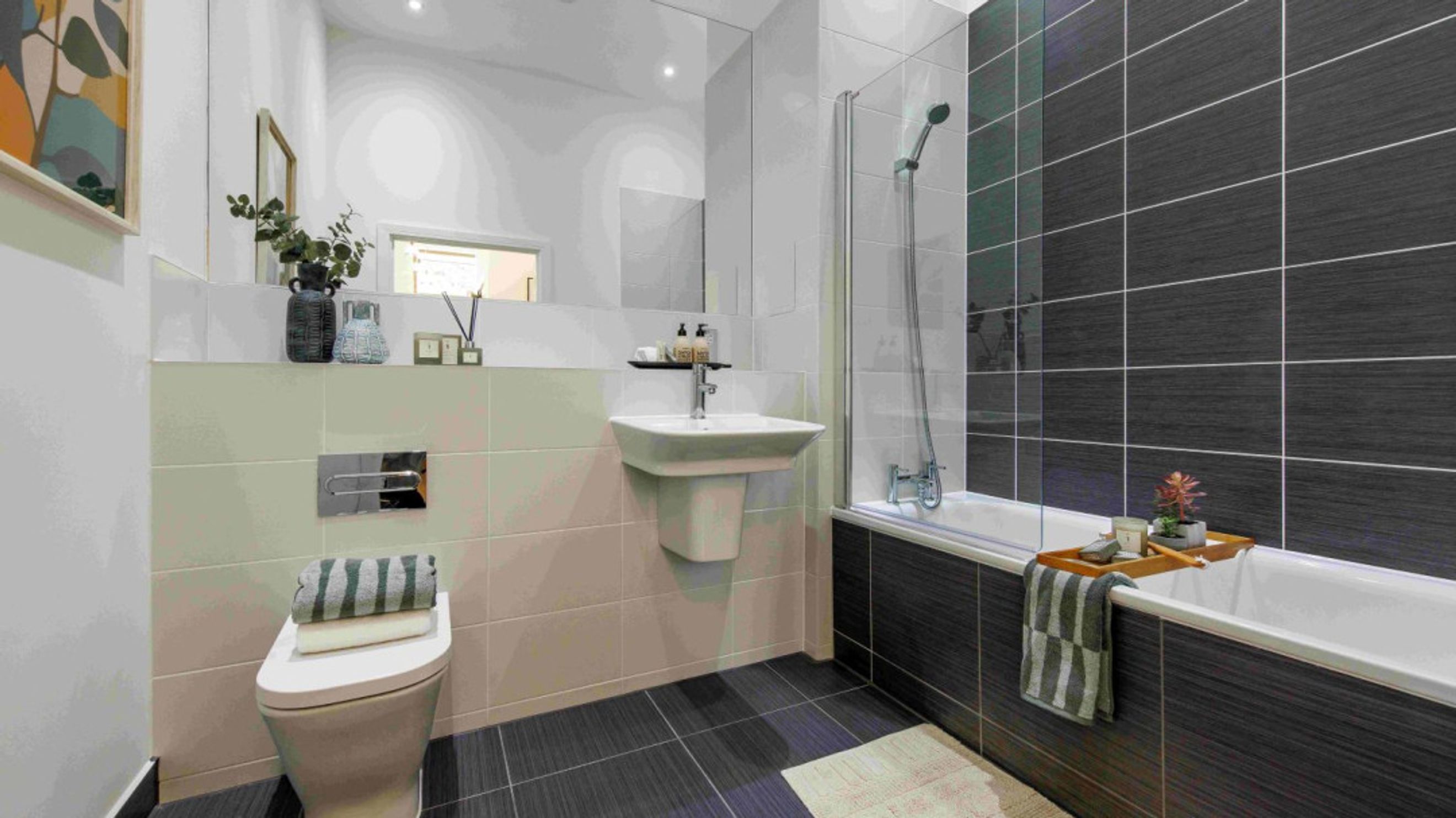 A bathroom with a toilet, sink, and bathtub.