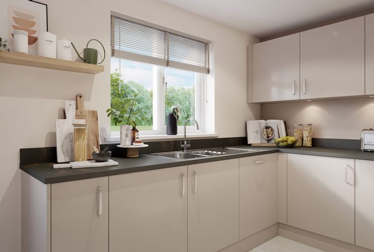 A modern kitchen with light-colored cabinets, a sink, and a window overlooking greenery.