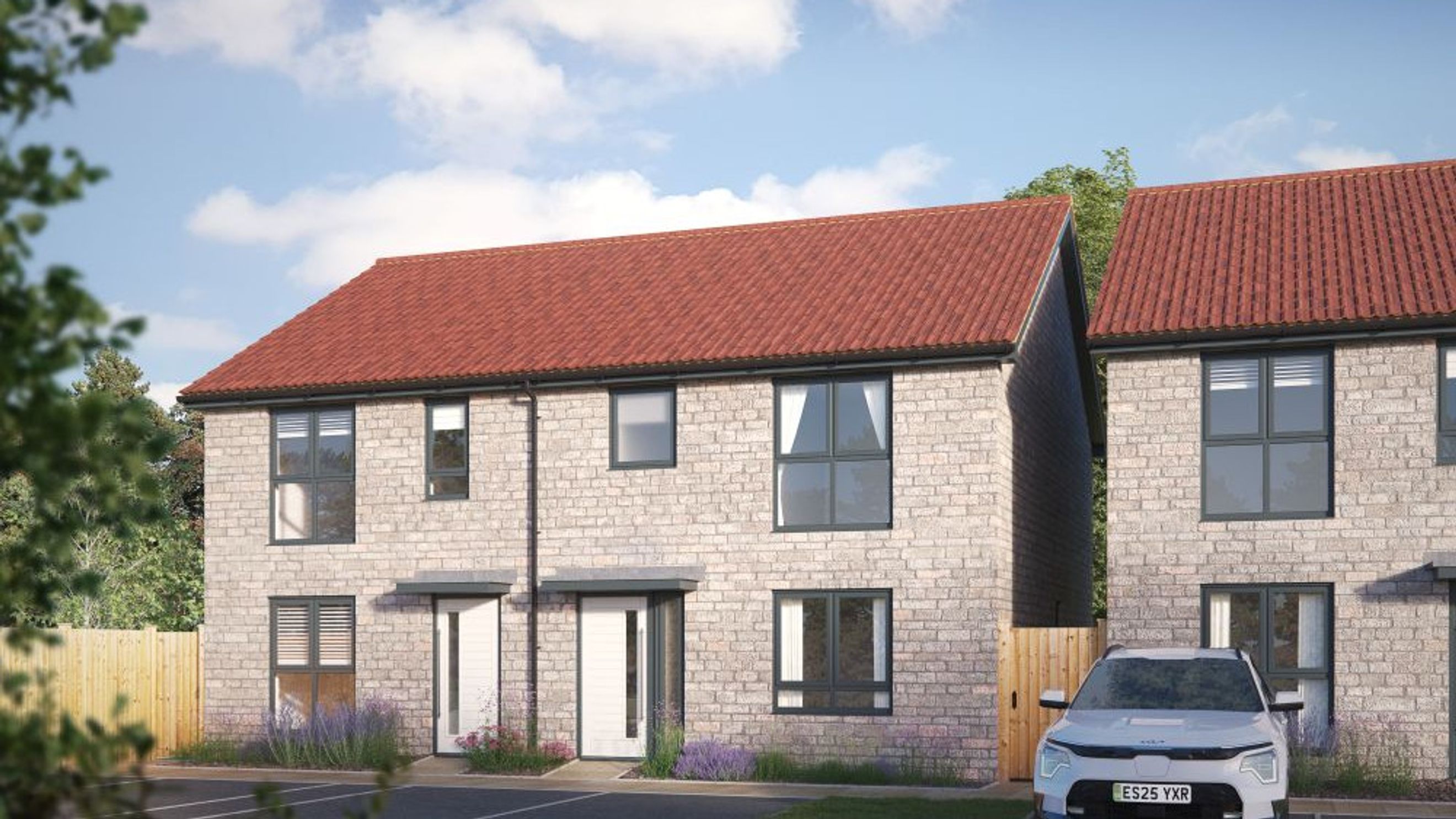 A pair of modern two-story houses with red tiled roofs and light brick exteriors.