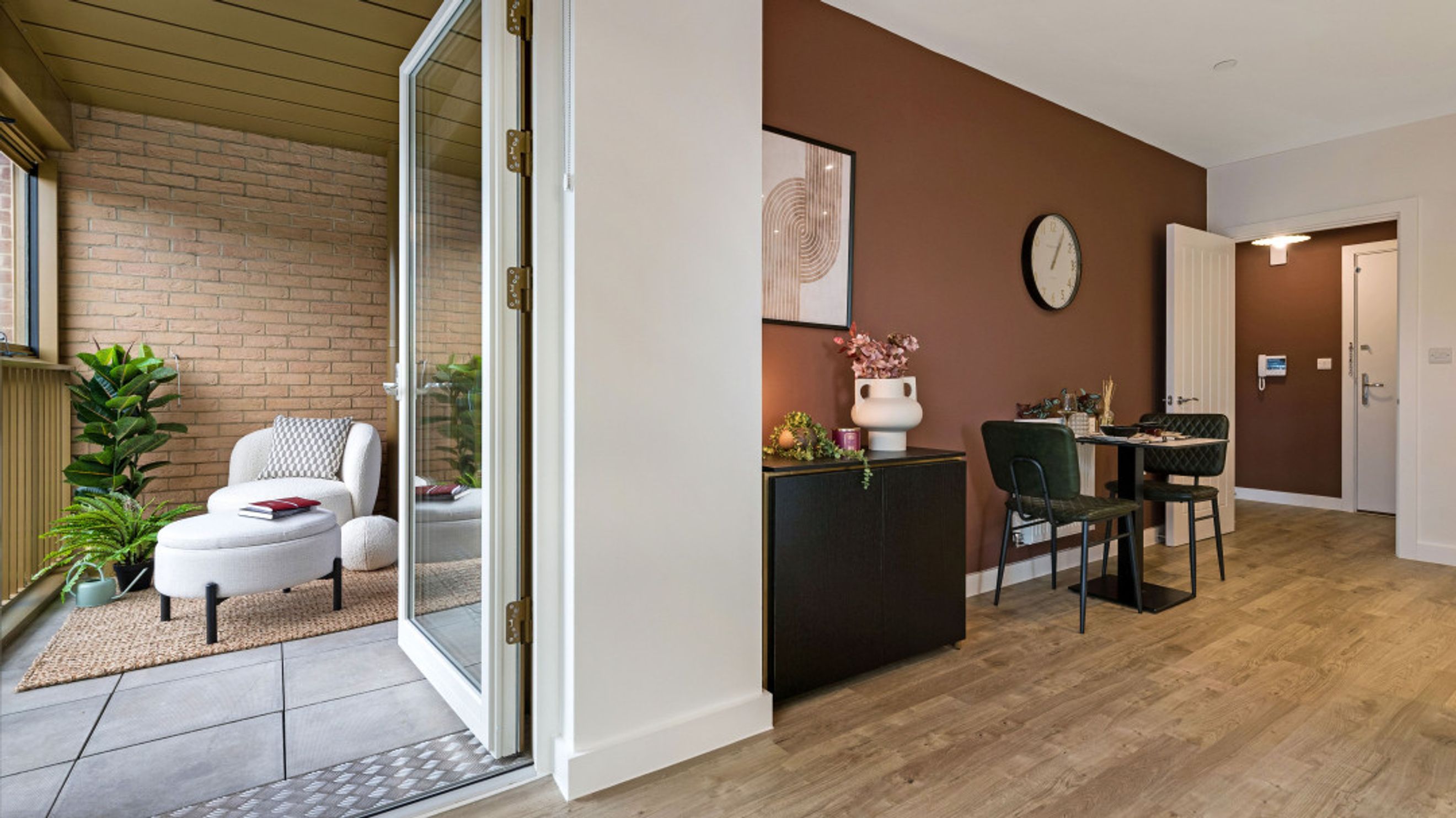 A balcony area with a chair and ottoman next to a dining area with a table and chairs.
