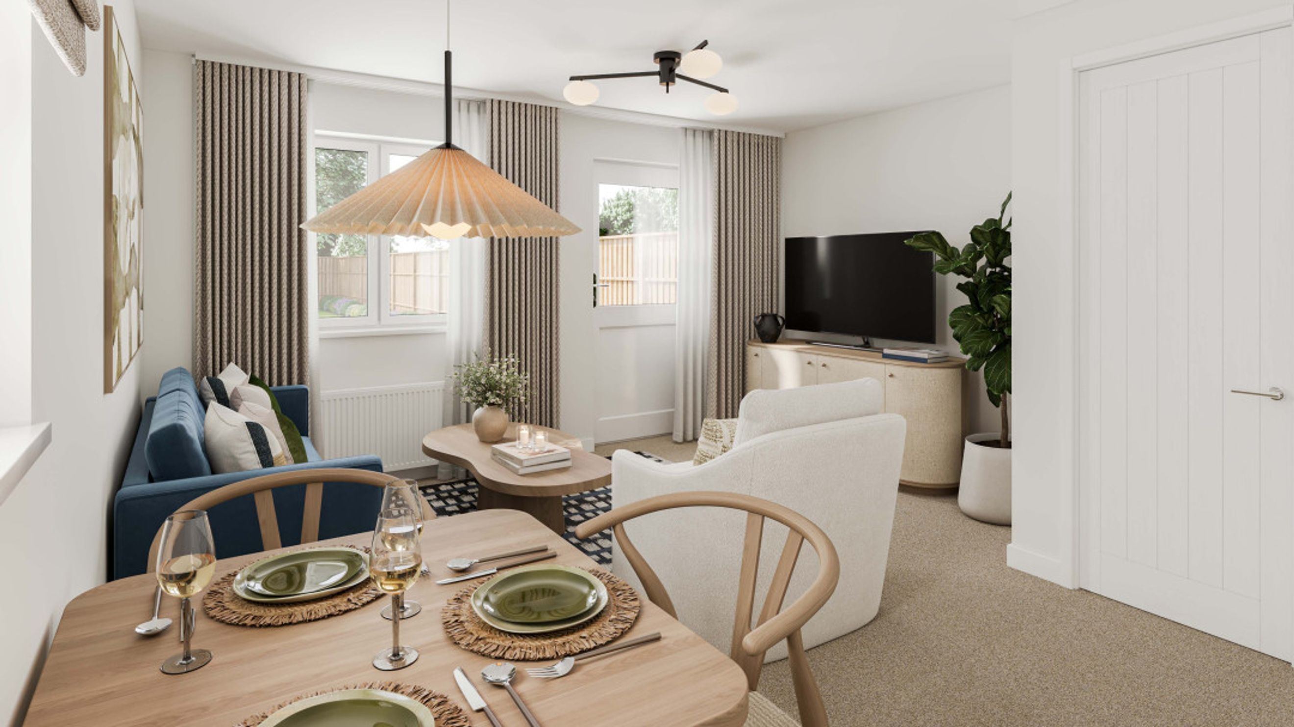 A dining and living room area with a table, chairs, sofa, armchair, and television.