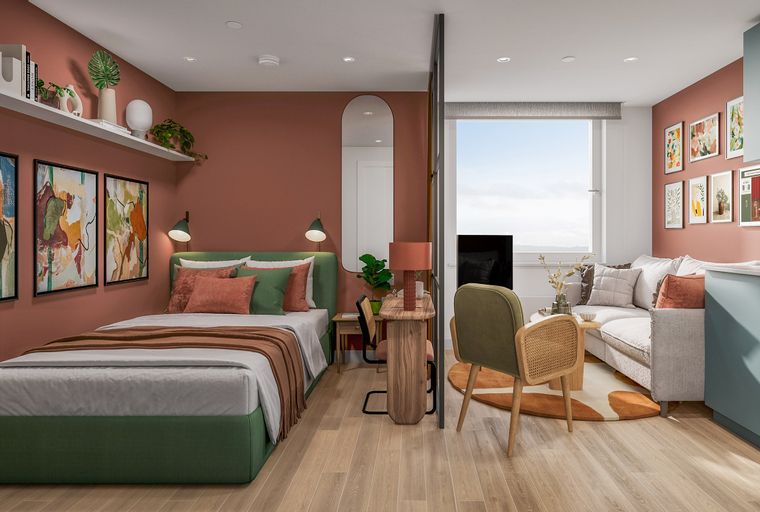 A studio apartment with a bed, sofa, kitchen, and a large window.