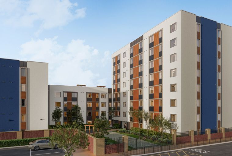 A modern apartment complex with multiple buildings, a courtyard, and a parking lot.