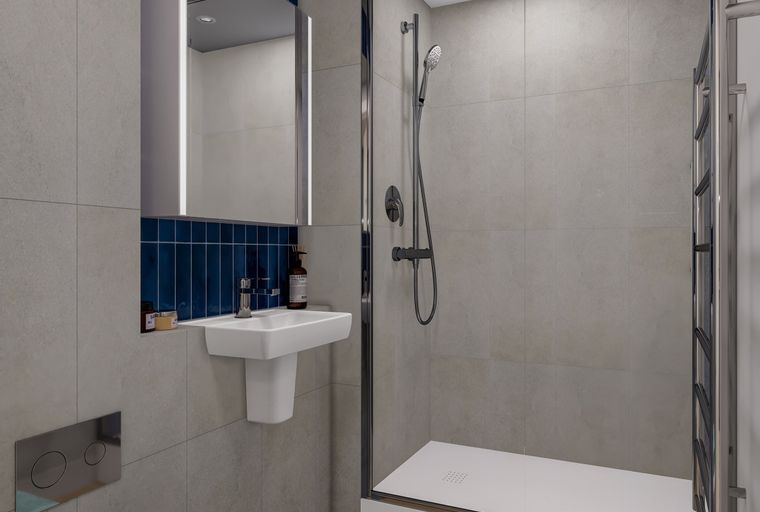 A modern bathroom with a walk-in shower, vanity, and toilet.