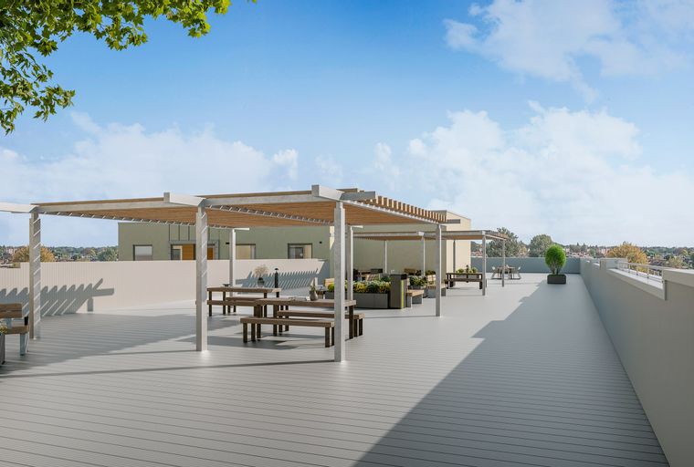 A rooftop terrace with pergolas, picnic tables, benches, and planters.
