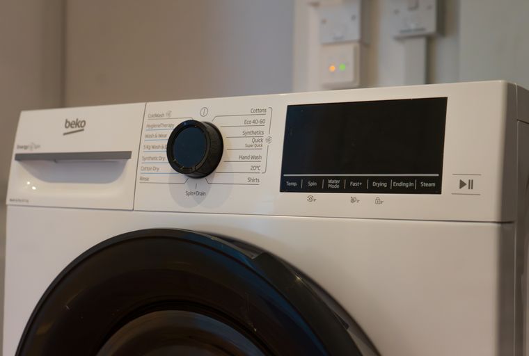 A white Beko washing machine with a control panel and a digital display.