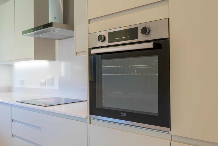 A modern kitchen with a built-in oven and an induction hob.