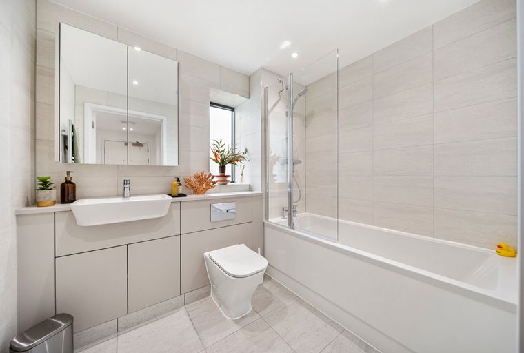 A bathroom with a sink, toilet, and bathtub.