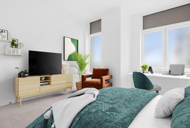 A bedroom with a bed, a TV, a desk, and a chair.