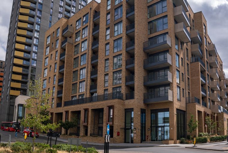 A modern apartment building with brick facade and balconies.