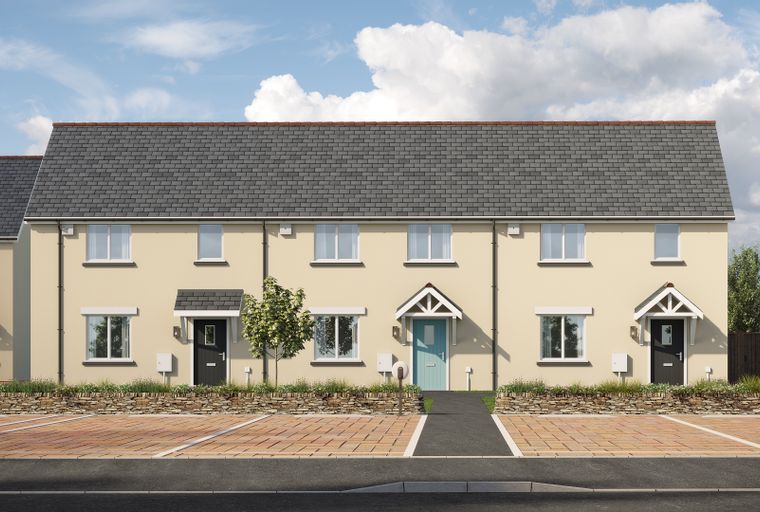 A row of beige townhouses with grey tiled roofs under a cloudy blue sky.