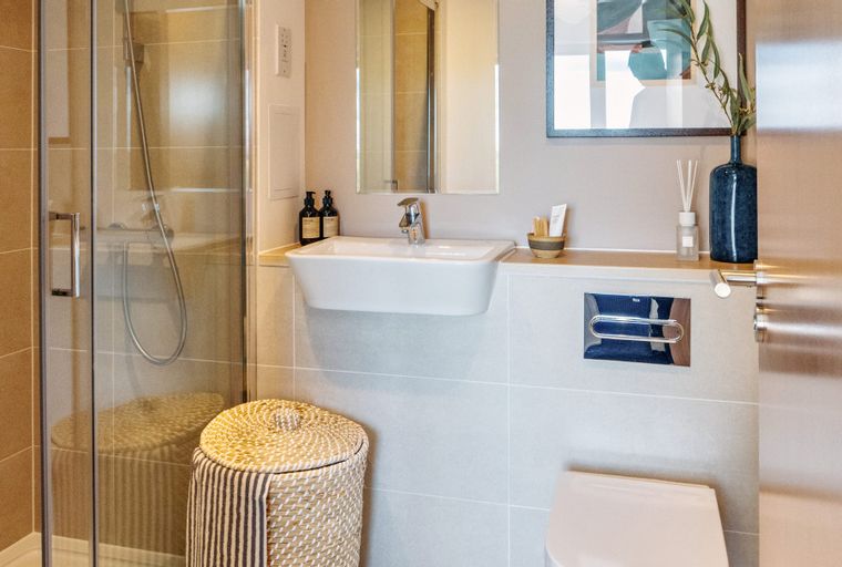 A bathroom with a shower, a sink, and a toilet.