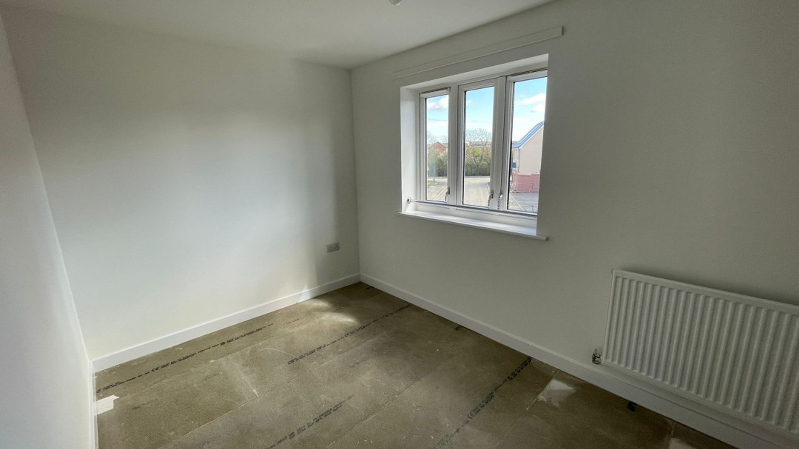 A room with a window and a radiator.