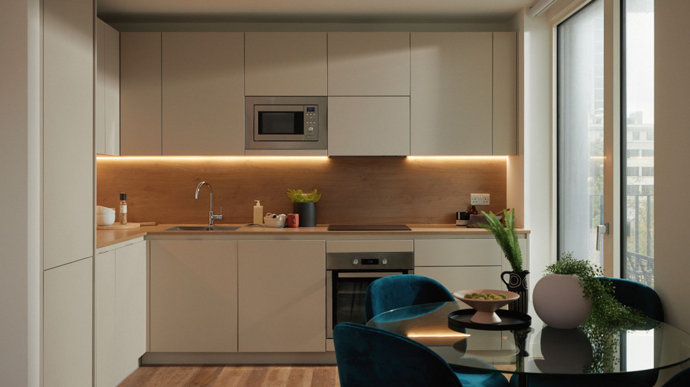 A modern kitchen with integrated appliances, under-cabinet lighting, and a dining area.