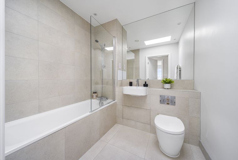 A bathroom with a bathtub, shower, sink, and toilet.