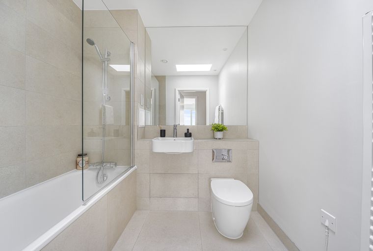 A bathroom with a bathtub, a sink, and a toilet.