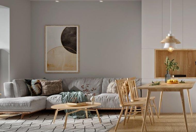 A living and dining area with a sectional sofa, coffee table, dining table, and chairs.