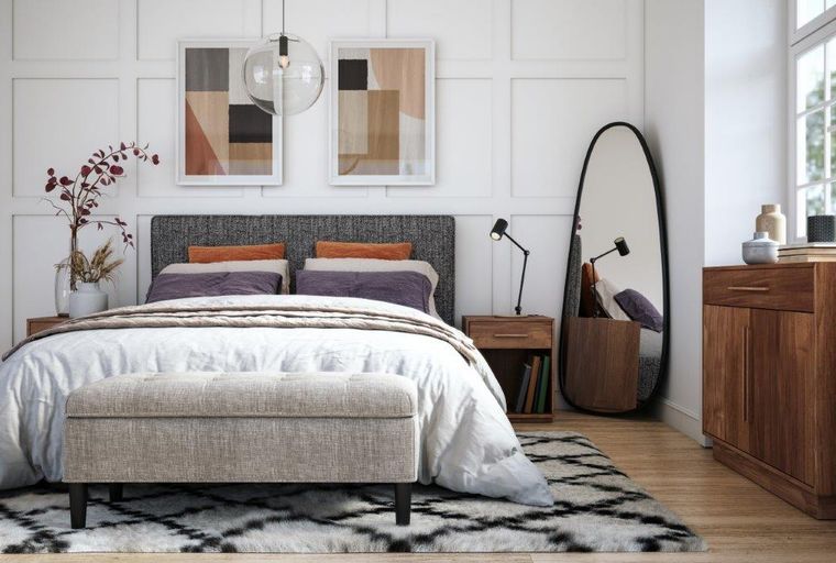 A bedroom with a bed, nightstands, a bench, and a mirror.