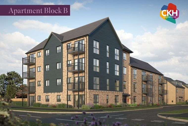 A modern apartment building with balconies and brick and dark cladding.