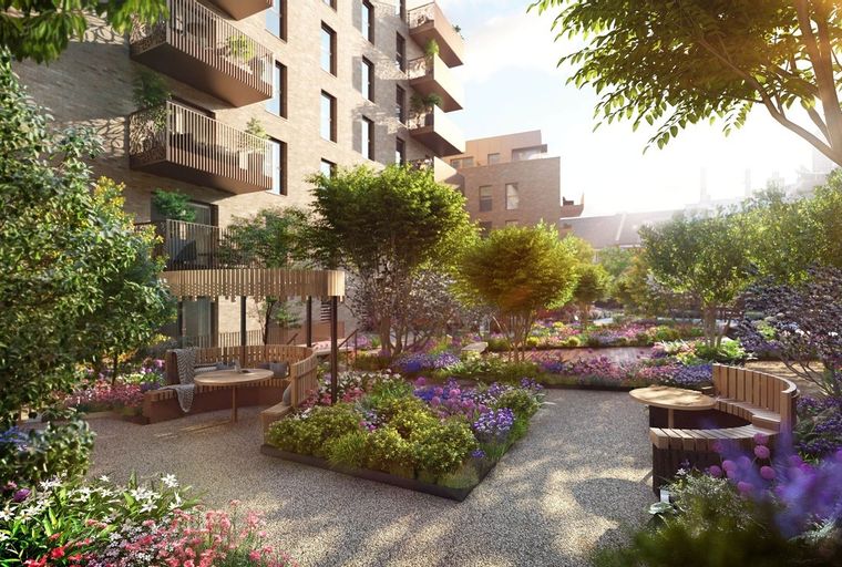 A modern apartment building with balconies overlooking a vibrant, landscaped garden with seating areas.